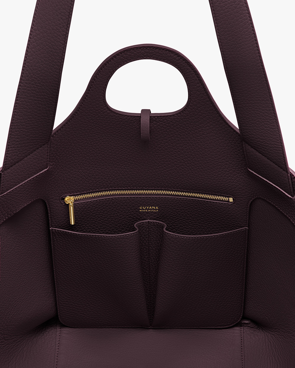 Open handbag with front zipper pocket and handle at the top.