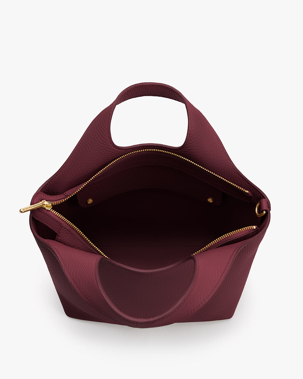 Top view of open bag with short handle and zipper closure.