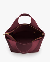 Top view of open bag with short handle and zipper closure.