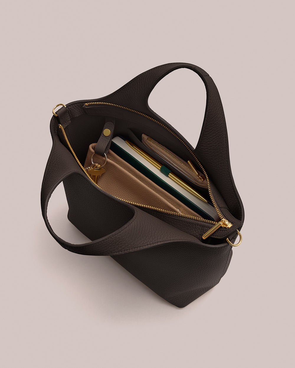 Open handbag with books and accessories inside