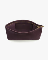 Open leather pouch with visible zipper and inner pocket