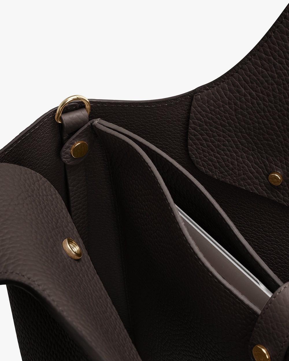 Open leather handbag with laptop sleeve attached via gold snap buttons