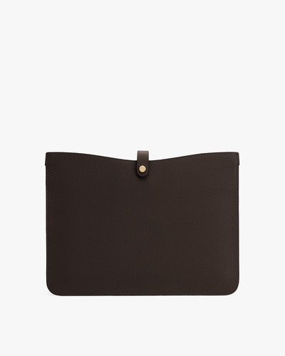 Leather laptop sleeve with a button closure at the top center.