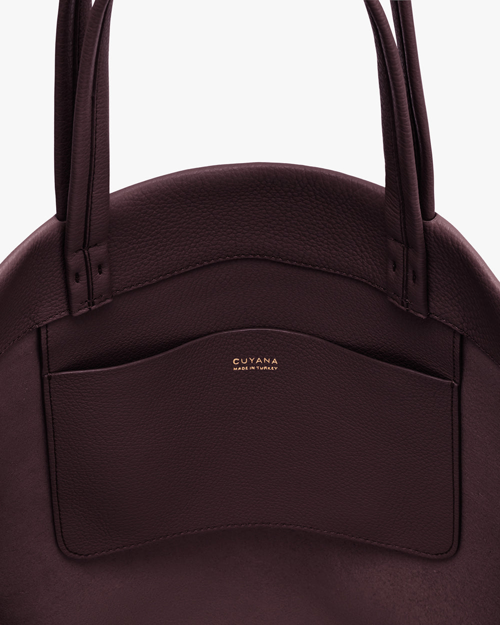 Close-up of a handbag with handles and a front pocket.