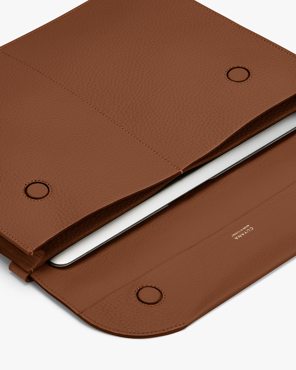 Open laptop sleeve with laptop and cable inside.