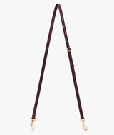 Adjustable bag strap with metal clasps on each end.