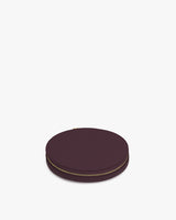 Round case with zipper closure lying flat on surface