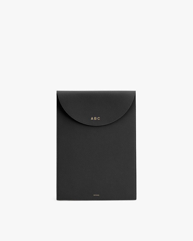 Black folder with an envelope-style flap and monogram initials ABC.