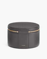 Round jewelry box with zipper on white background.