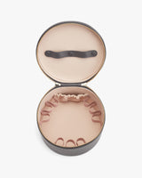 Round case open showing top handle and interior compartments.