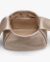 Open handbag showing interior and handle.