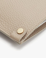 Close-up of a textured wallet with a snap closure.