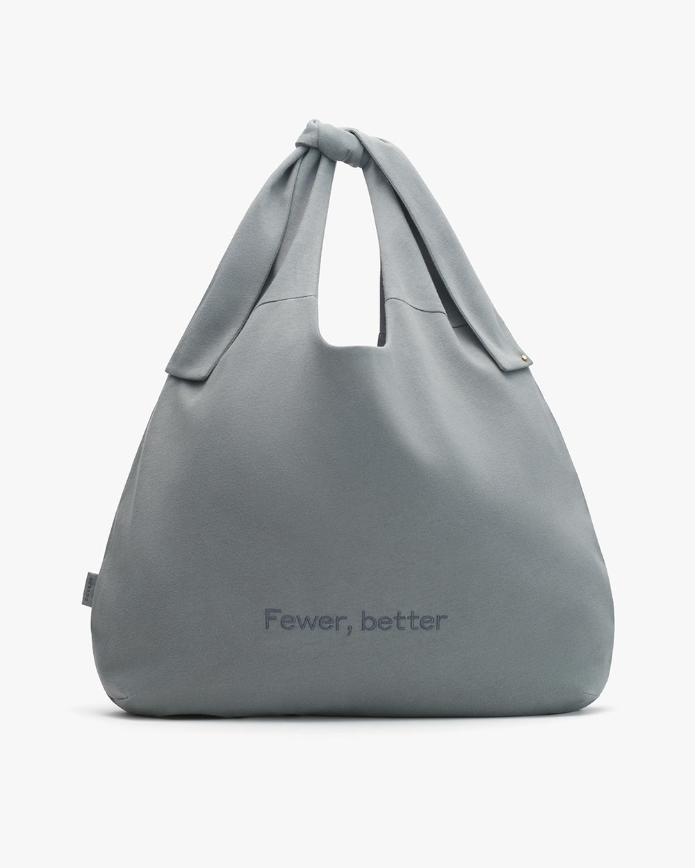Handbag with handle and the text 'Fewer, better' printed on the front.