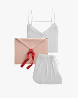 Assortment of a camisole top, drawstring bag, and an envelope with a ribbon.