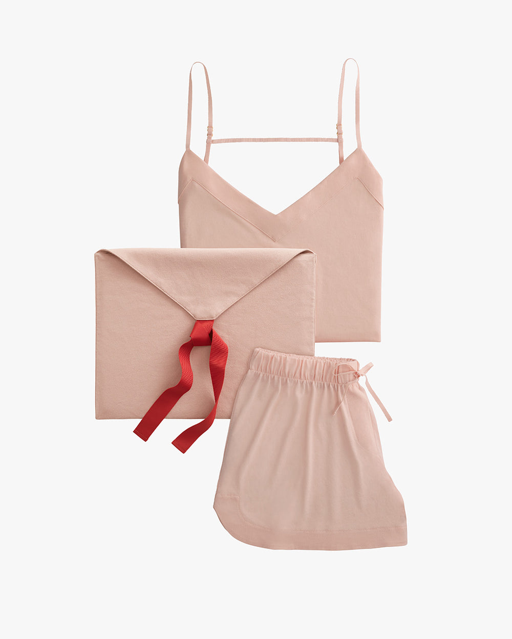 Camisole, envelope with ribbon, and drawstring pouch arranged on a plain background.