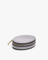 Round case with a zipper on a plain background.