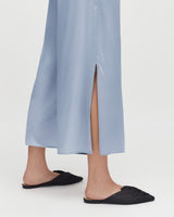 Person wearing flats and a long skirt with a front slit.