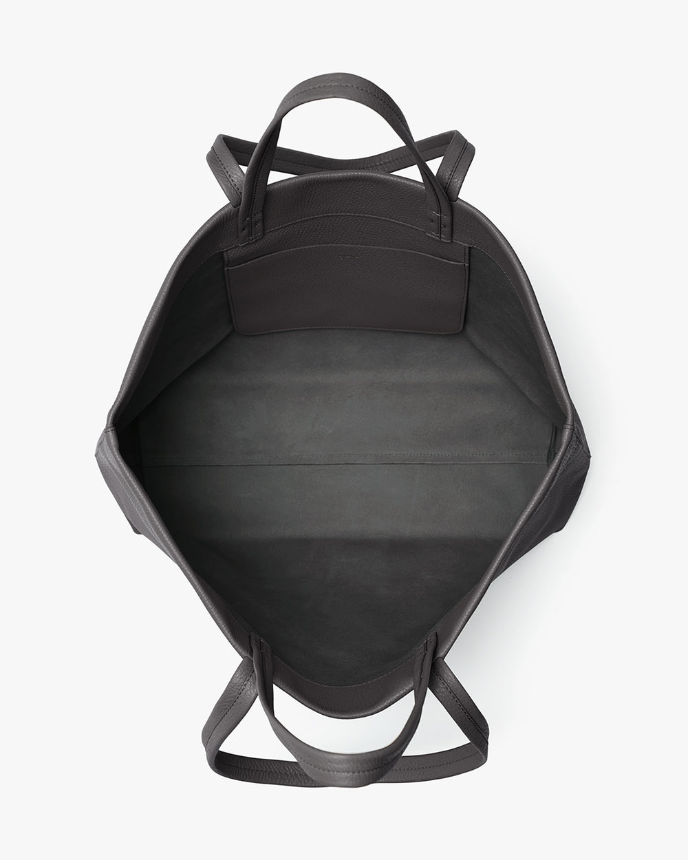 View of a travel bag from the top showing its inner compartment with handles on the sides.