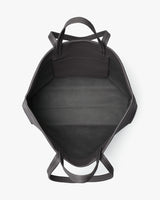 View of a travel bag from the top showing its inner compartment with handles on the sides.