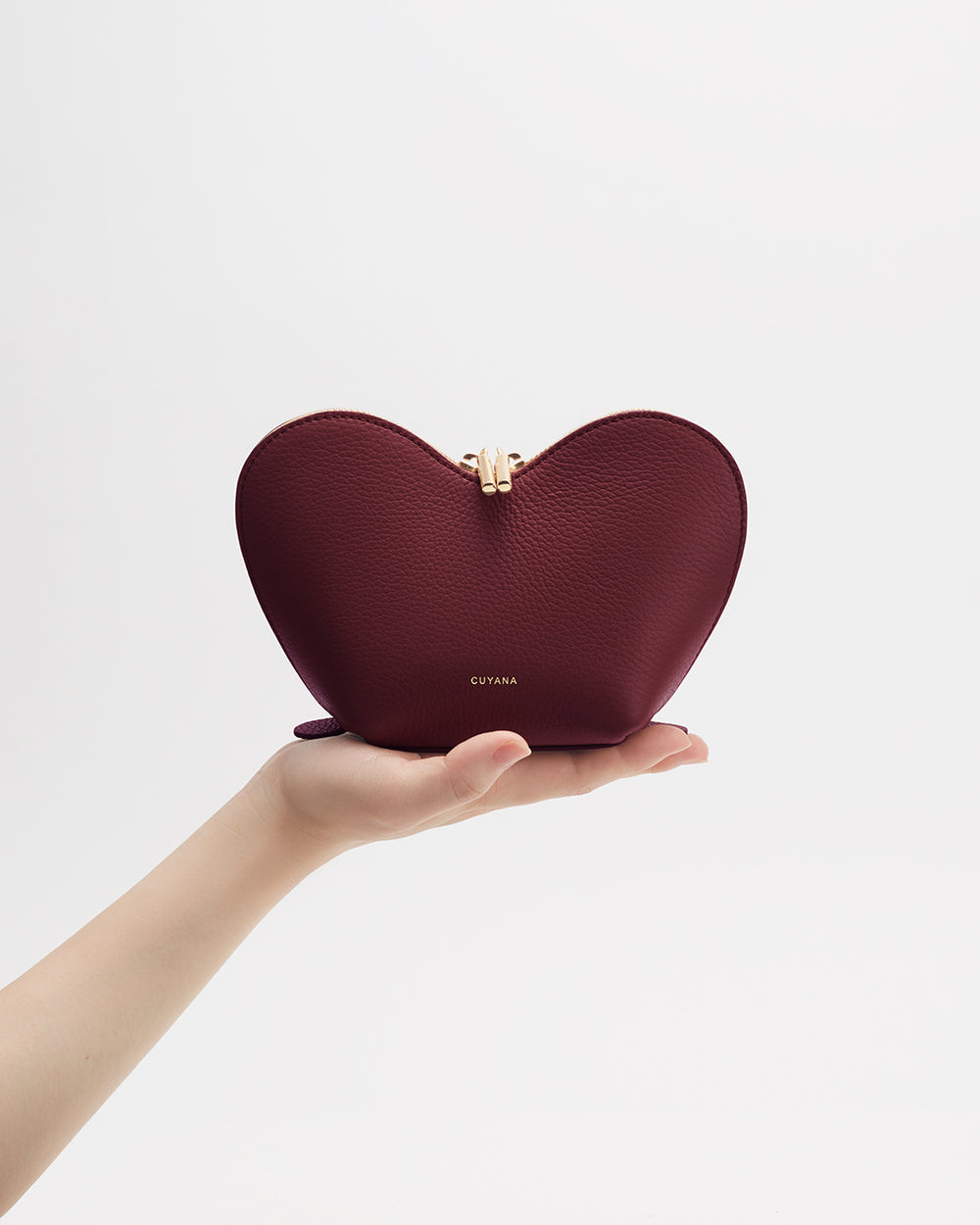 Heart-shaped pouch held by a hand