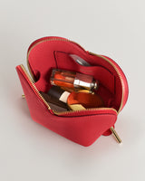 Small open pouch containing bottles and a compact.