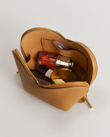 Small zippered pouch with various cosmetics inside