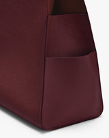Close-up of a textured bag with a side pocket.