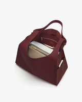 Open tote bag with purse and small pouch inside.