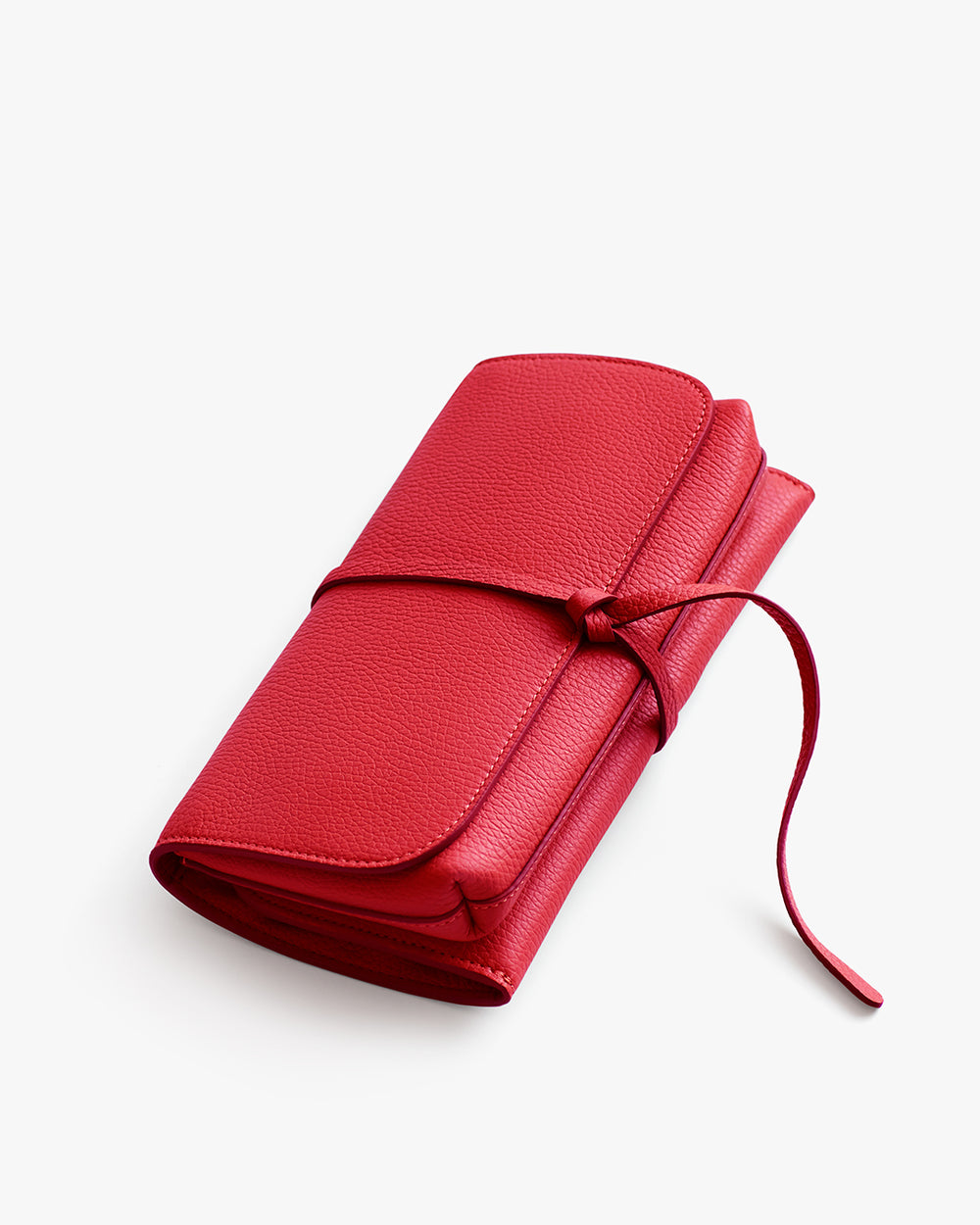 Folded leather pouch with a wrap-around tie.