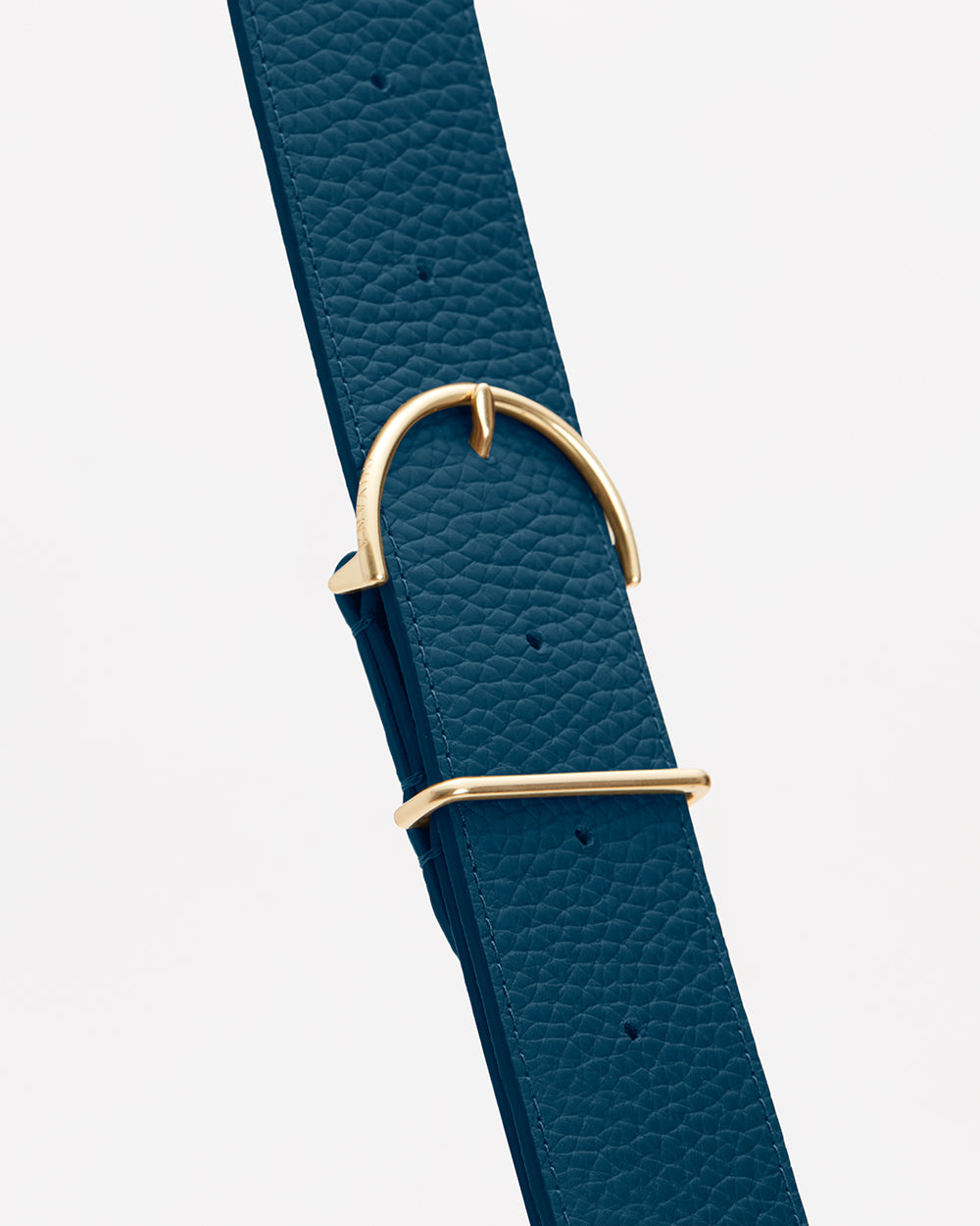 Textured belt with a gold buckle and loop.