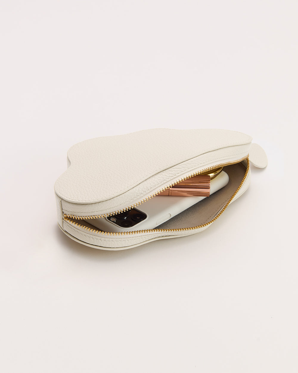 Cloud-shaped pouch with a zip, partially open showing items inside.