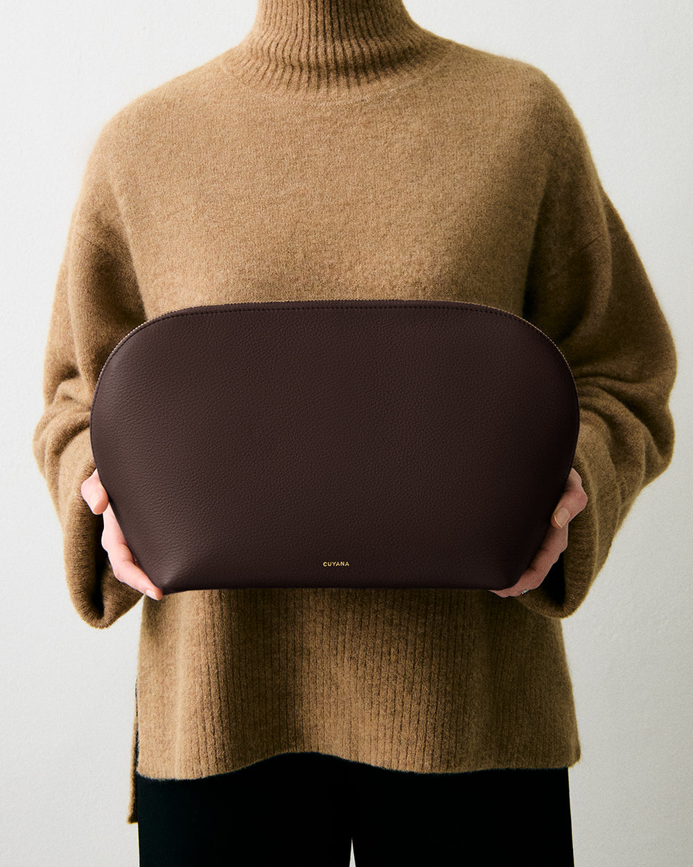 Person holding large pouch with both hands