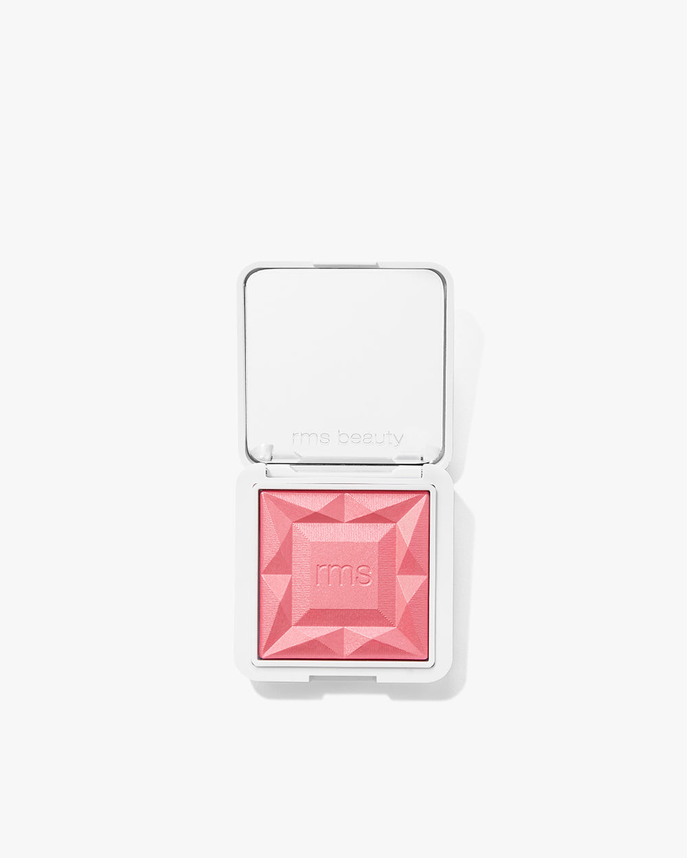 Makeup blush compact with geometric design on powder surface.