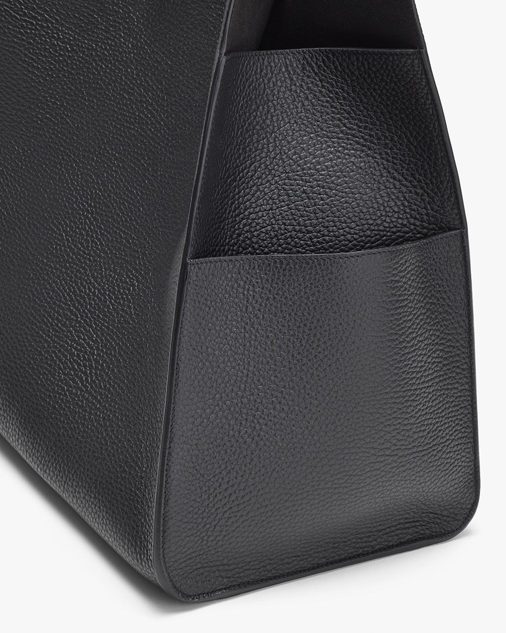 Close-up view of a textured bag with an exterior pocket.