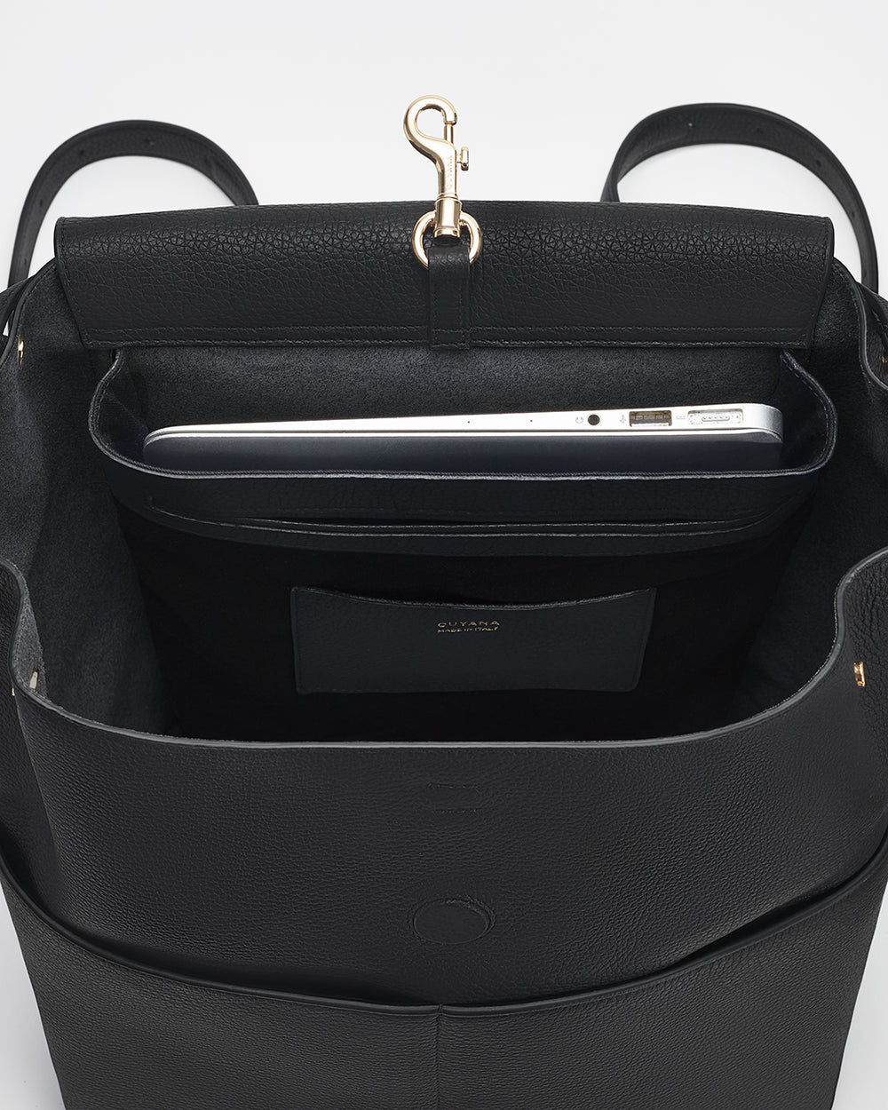 Open bag with a laptop inside and a clasp on the top.