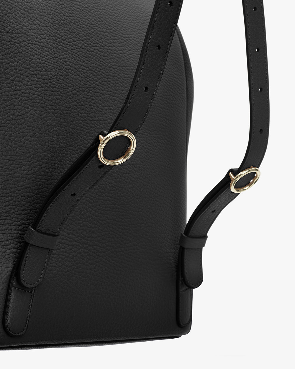 Close-up of a bag with a shoulder strap and metal rings.