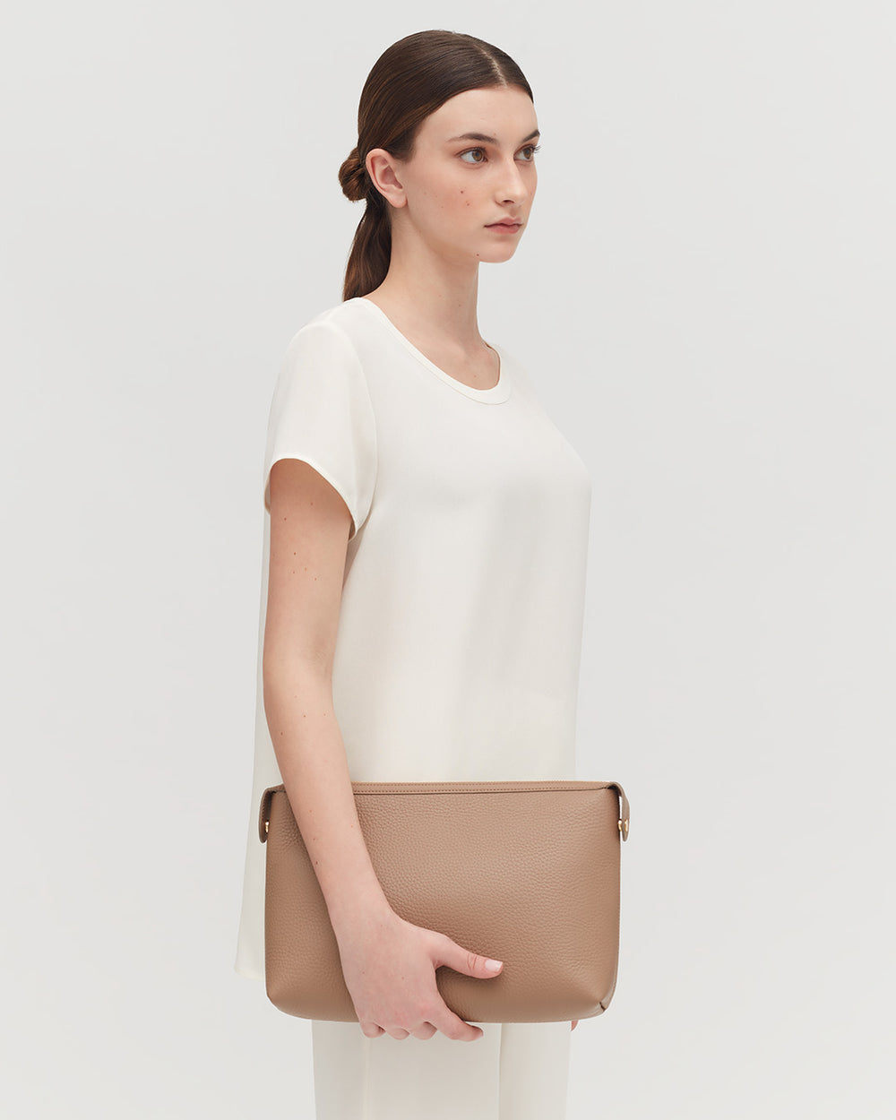 Woman standing with a handbag over her shoulder