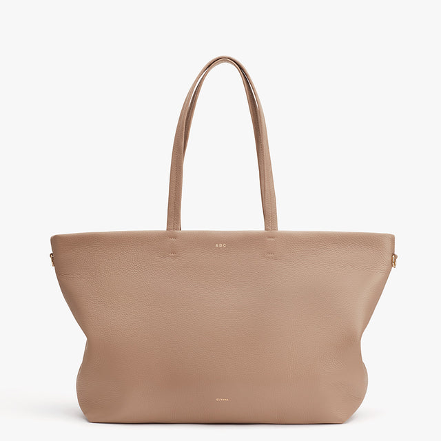 Large handbag with two handles and logo on front.