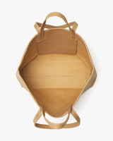 Top view of an open empty handbag with handles