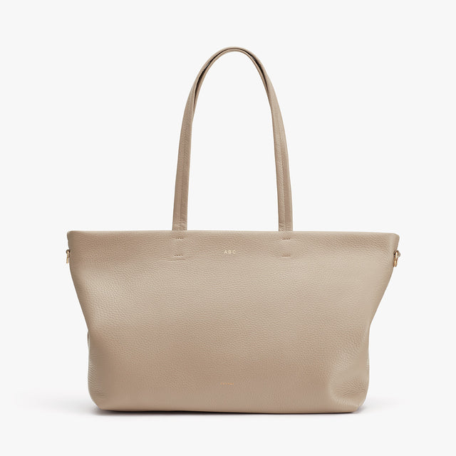 Tote bag with two handles, standing upright against a plain background.
