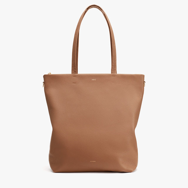 Leather tote bag with two handles and a zipper closure.