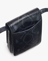 Textured shoulder bag with flap front and strap.