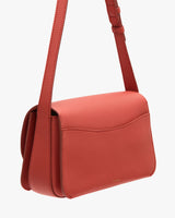 Small shoulder bag with a structured design and a flap closure.
