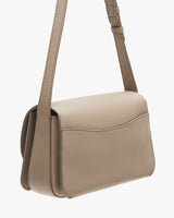 Small shoulder bag with a flap closure and adjustable strap.