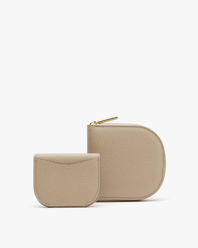 Two small zippered pouches, one slightly larger than the other, displayed upright.
