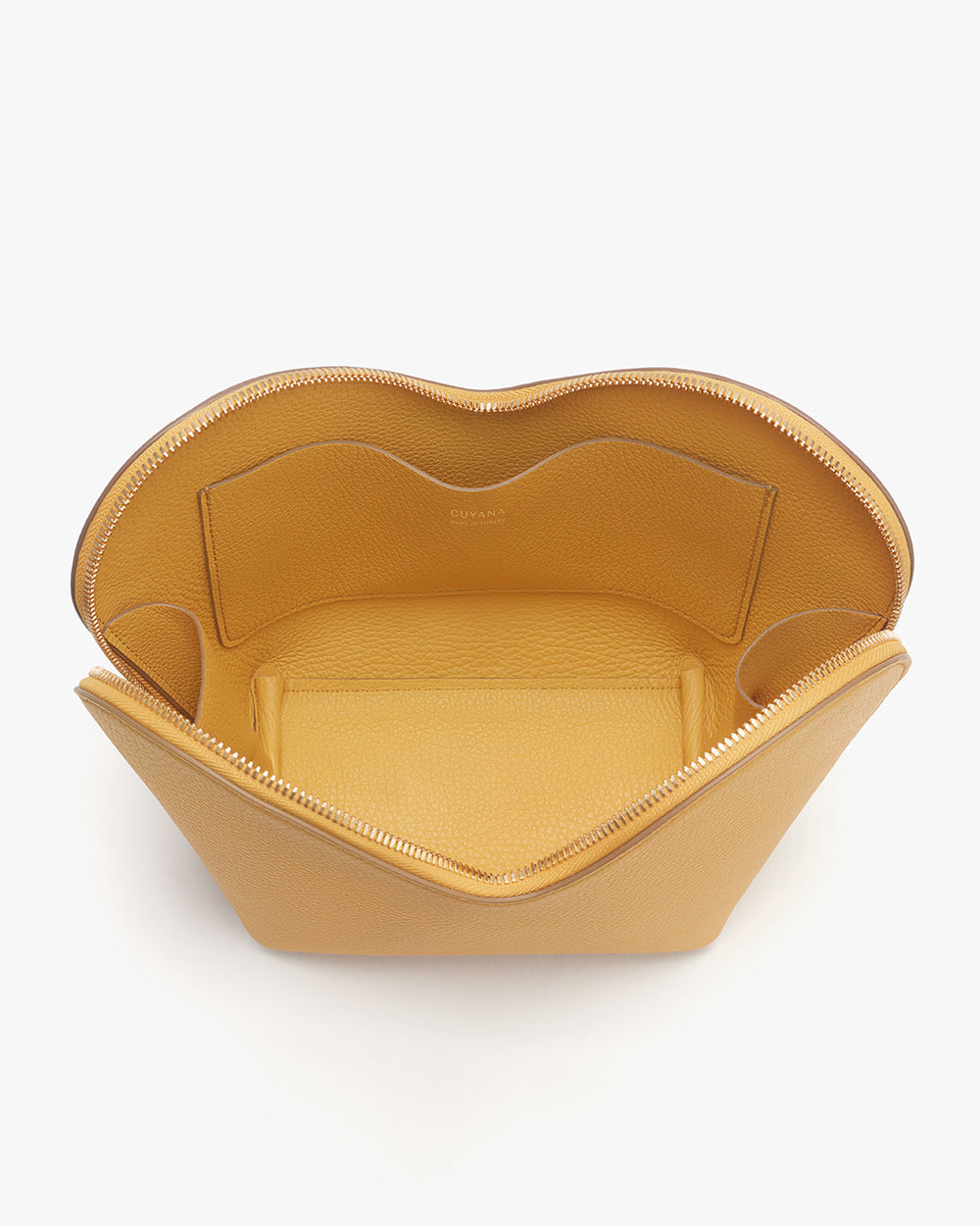 Open leather container with zipper on a plain background.