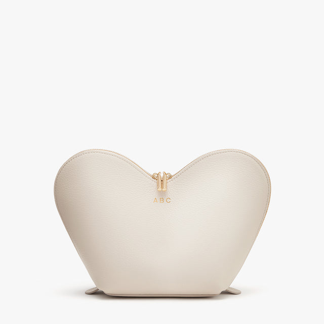 Heart-shaped purse with zipper and initials ABC on the front.