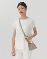 Woman standing with a shoulder bag
