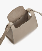 Open handbag with a flap and an adjustable strap.
