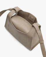 Open handbag with adjustable strap and visible interior.
